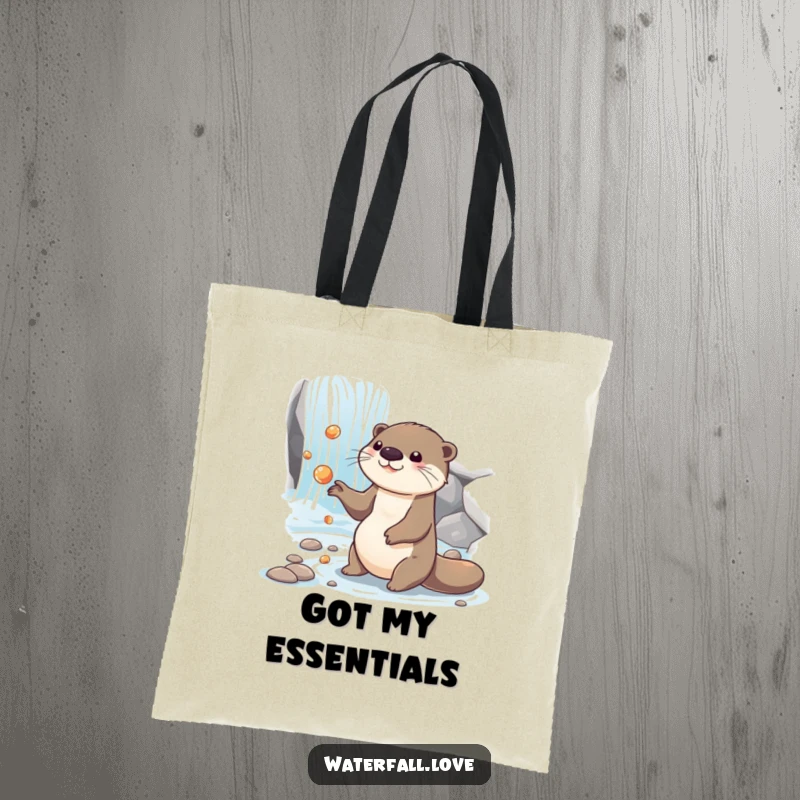 Funny otter juggling shiny pebbles near a cascading waterfall, featured on a durable and funny tote bag.